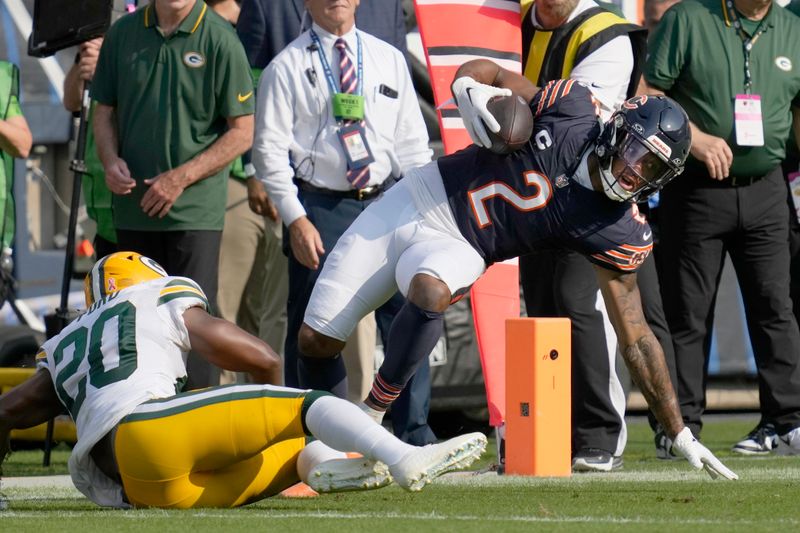 Chicago Bears wide receiver DJ Moore (2) is tackled by Green Bay Packers safety Rudy Ford during the first half of an NFL football game Sunday, Sept. 10, 2023, in Chicago. (AP Photo/Nam Y. Huh)