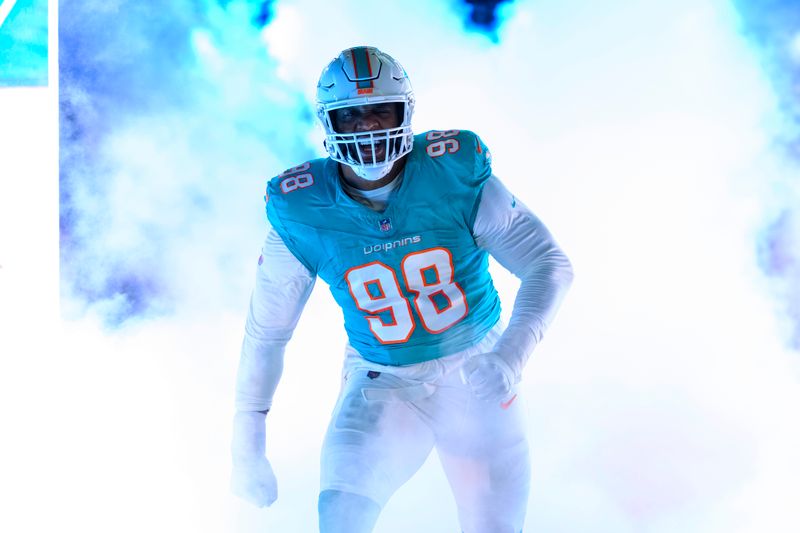 Miami Dolphins defensive tackle Raekwon Davis (98) yells and reacts during player introductions before the start of an NFL football game against the Tennessee Titans, Monday, Dec. 12, 2023, in Miami Gardens, Fla. (AP Photo/Doug Murray)