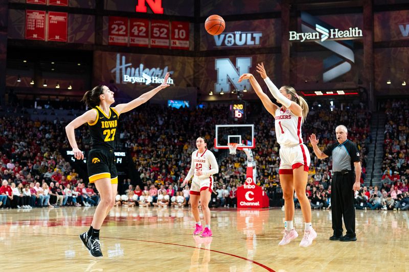 Feb 11, 2024; Lincoln, Nebraska, USA; Nebraska Cornhuskers guard Jaz Shelley (1) shoots a three point shot against Iowa Hawkeyes guard Caitlin Clark (22) during the first quarter at Pinnacle Bank Arena. Mandatory Credit: Dylan Widger-USA TODAY Sports