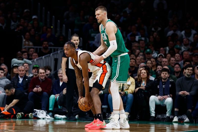 BOSTON, MA - DECEMBER 4: Kristaps Porzingis #8 of the Boston Celtics defends against Ronald Holland II #00 of the Detroit Pistons during the first quarter at TD Garden on December 4, 2024 in Boston, Massachusetts. NOTE TO USER: User expressly acknowledges and agrees that, by downloading and/or using this Photograph, user is consenting to the terms and conditions of the Getty Images License Agreement. (Photo By Winslow Townson/Getty Images)