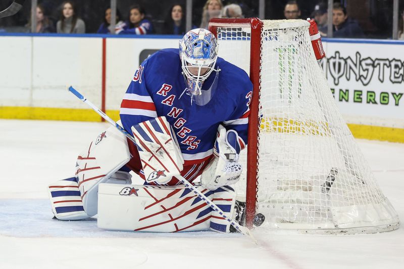Apr 2, 2025; New York, New York, USA;  New York Rangers goaltender Igor Shesterkin (31) deflects the puck away in the first period against the Minnesota Wild at Madison Square Garden. Mandatory Credit: Wendell Cruz-Imagn Images