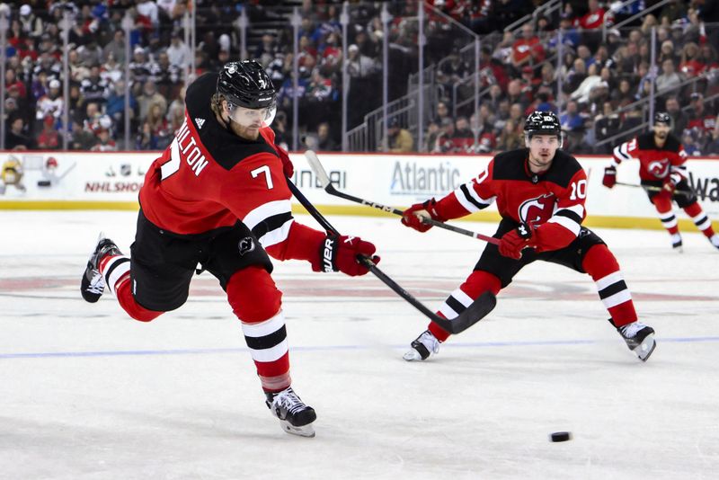 Nov 18, 2023; Newark, New Jersey, USA; New Jersey Devils defenseman Dougie Hamilton (7) shoots the puck against the New York Rangers during the second period at Prudential Center. Mandatory Credit: John Jones-USA TODAY Sports