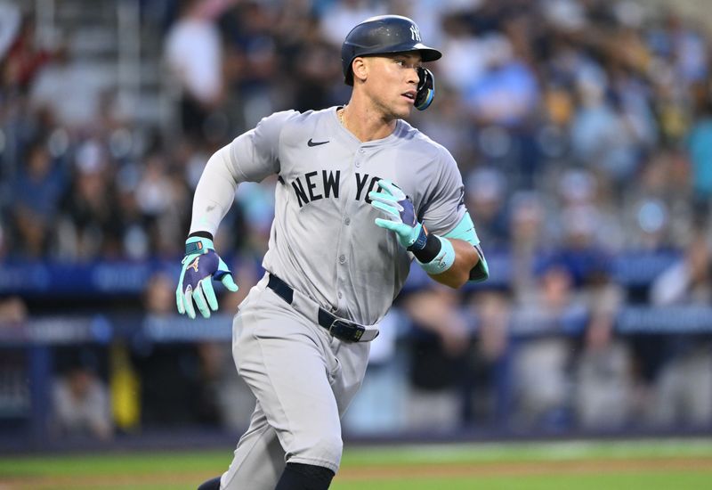 Aug 18, 2024; Williamsport, Pennsylvania, USA; New York Yankees outfielder Aaron Judge (99) runs to first after hitting a single against the Detroit Tigers in the fourth inning at BB&T Ballpark at Historic Bowman Field. Mandatory Credit: Kyle Ross-USA TODAY Sports