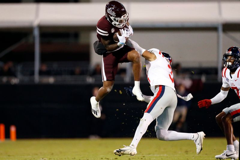 Nov 23, 2023; Starkville, Mississippi, USA; Mississippi State Bulldogs wide receiver Zavion Thomas (1) catches the ball as Mississippi Rebels defensive back Daijahn Anthony (3) defends during the first half at Davis Wade Stadium at Scott Field. Mandatory Credit: Petre Thomas-USA TODAY Sports