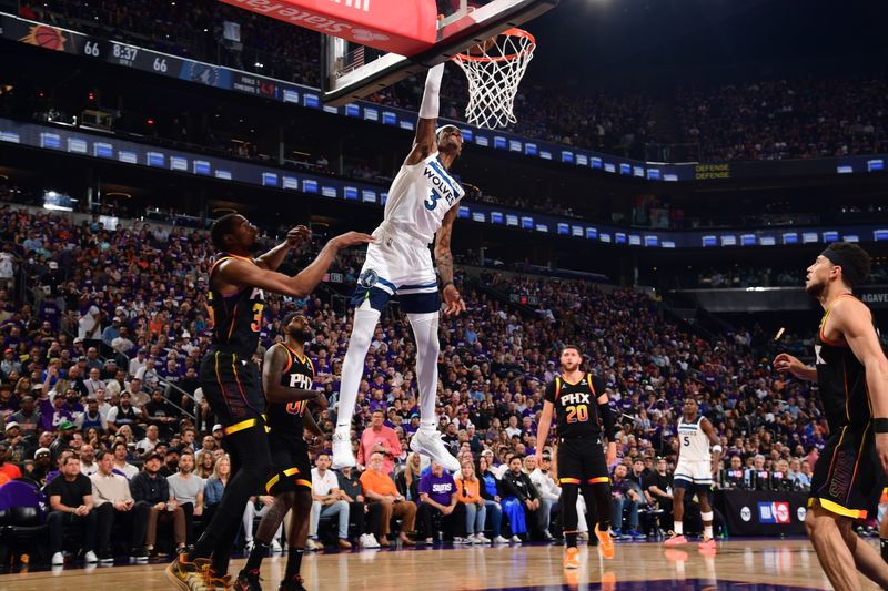 PHOENIX, AZ - APRIL  28: Jaden McDaniels #3 of the Minnesota Timberwolves dunks the ball during the game against the Phoenix Suns during Round 1 Game 4 of the 2024 NBA Playoffs on April 28, 2024 at Footprint Center in Phoenix, Arizona. NOTE TO USER: User expressly acknowledges and agrees that, by downloading and or using this photograph, user is consenting to the terms and conditions of the Getty Images License Agreement. Mandatory Copyright Notice: Copyright 2024 NBAE (Photo by Kate Frese/NBAE via Getty Images)