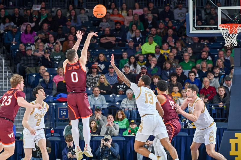 Feb 10, 2024; South Bend, Indiana, USA; Virginia Tech Hokies guard Hunter Cattoor (0) shoots over Notre Dame Fighting Irish forward Tae Davis (13) in the first half at the Purcell Pavilion. Mandatory Credit: Matt Cashore-USA TODAY Sports