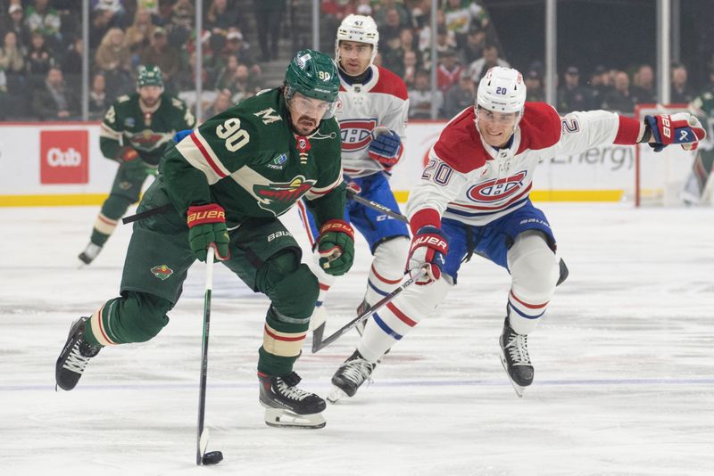 Dec 21, 2023; Saint Paul, Minnesota, USA; Minnesota Wild left wing Marcus Johansson (90) is pursued over the blue line by Montreal Canadiens left wing Juraj Slafkovsky (20) in the first period at Xcel Energy Center. Mandatory Credit: Matt Blewett-USA TODAY Sports