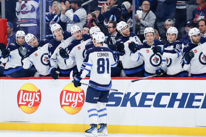 Oct 28, 2024; Winnipeg, Manitoba, CAN;  Winnipeg Jets forward Kyle Connor (81) is congratulated by his team mates on his goal against the Toronto Maple Leafs during the second period at Canada Life Centre. Mandatory Credit: Terrence Lee-Imagn Images