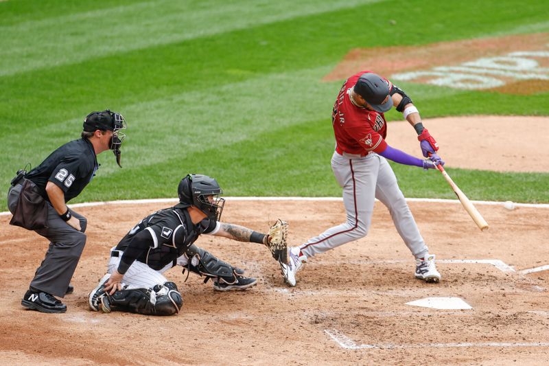 Sep 28, 2023; Chicago, Illinois, USA; Arizona Diamondbacks left fielder Lourdes Gurriel Jr. (12) singles against the Chicago White Sox during the fourth inning at Guaranteed Rate Field. Mandatory Credit: Kamil Krzaczynski-USA TODAY Sports