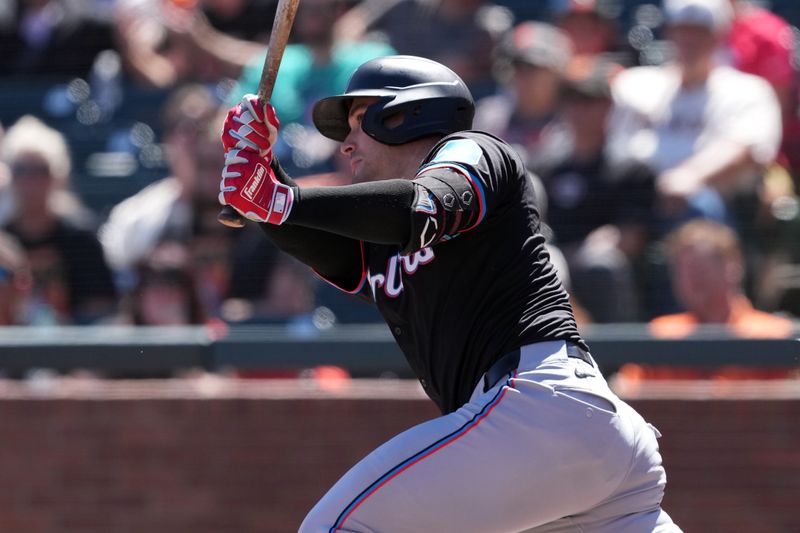 Sep 1, 2024; San Francisco, California, USA; Miami Marlins catcher Nick Fortes (4) hits an RBI single against the San Francisco Giants during the fifth inning at Oracle Park. Mandatory Credit: Darren Yamashita-USA TODAY Sports