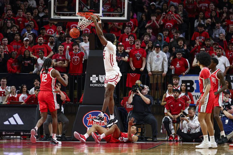 Mar 10, 2024; Piscataway, New Jersey, USA; Rutgers Scarlet Knights center Emmanuel Ogbole (22) dunks the ball in front of Ohio State Buckeyes guard Evan Mahaffey (12) during the first half at Jersey Mike's Arena. Mandatory Credit: Vincent Carchietta-USA TODAY Sports