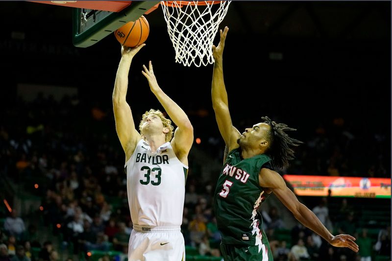 Dec 22, 2023; Waco, Texas, USA; Baylor Bears forward Caleb Lohner (33) shoots over Mississippi Valley State Delta Devils forward Walter Hamilton (5) during the second half at Ferrell Center. Mandatory Credit: Raymond Carlin III-USA TODAY Sports