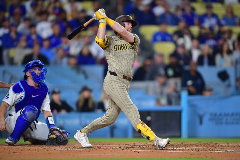 Sep 24, 2024; Los Angeles, California, USA; San Diego Padres second baseman Jake Cronenworth (9) hits a two run home run against the Los Angeles Dodgers during the second inning at Dodger Stadium. Mandatory Credit: Gary A. Vasquez-Imagn Images