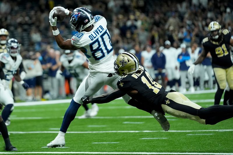 Tennessee Titans wide receiver Bryce Oliver catches a touchdown pass over New Orleans Saints cornerback Joejuan Williams during the second half of an NFL preseason football game, Sunday, Aug. 25, 2024, in New Orleans. (AP Photo/Gerald Herbert)