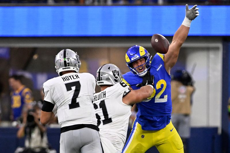 Los Angeles Rams defensive end Jonah Williams, right, blocks a pass from Las Vegas Raiders quarterback Brian Hoyer during the first half of a preseason NFL football game Saturday, Aug. 19, 2023, in Inglewood, Calif. (AP Photo/Alex Gallardo)