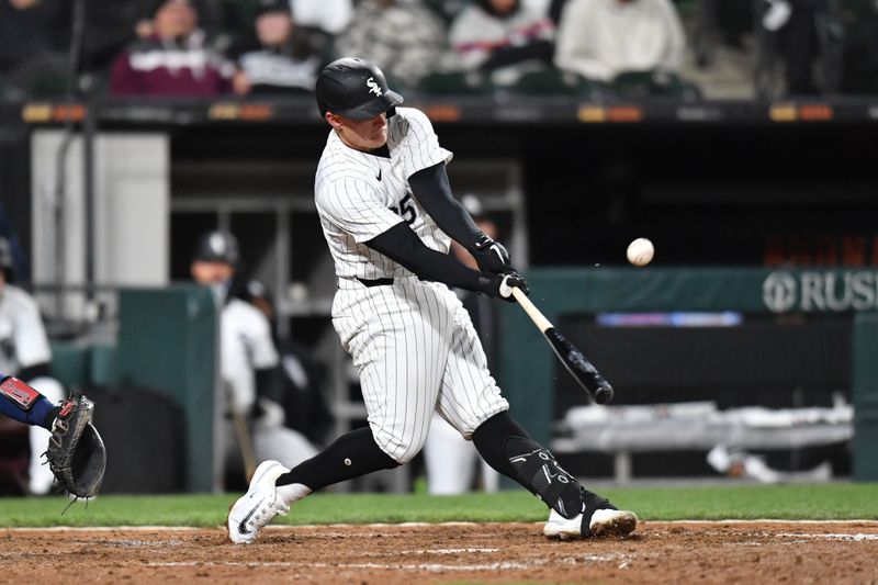 Apr 2, 2024; Chicago, Illinois, USA; Chicago White Sox first baseman Andrew Vaughn (25) hits an RBI single during the eighth inning against the Atlanta Braves at Guaranteed Rate Field. Mandatory Credit: Patrick Gorski-USA TODAY Sports