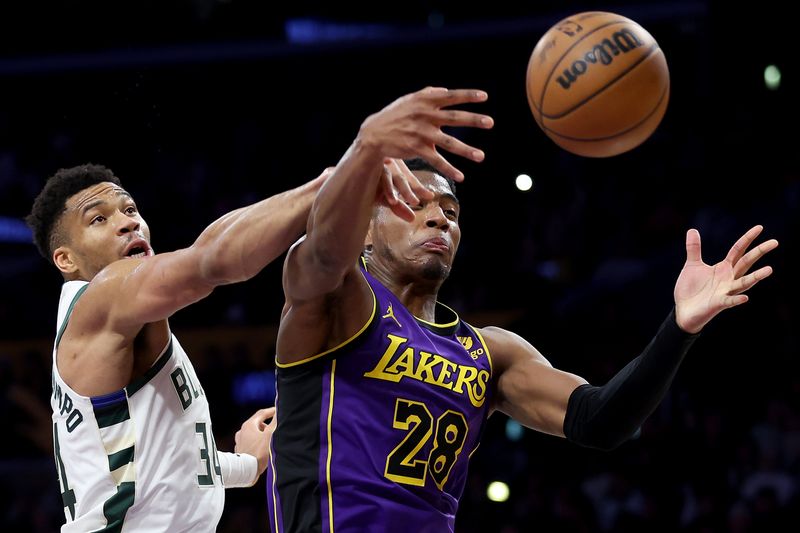 LOS ANGELES, CALIFORNIA - MARCH 08: Giannis Antetokounmpo #34 of the Milwaukee Bucks battles Rui Hachimura #28 of the Los Angeles Lakers for a loose ball during the first half of a game at Crypto.com Arena on March 08, 2024 in Los Angeles, California. (Photo by Sean M. Haffey/Getty Images)