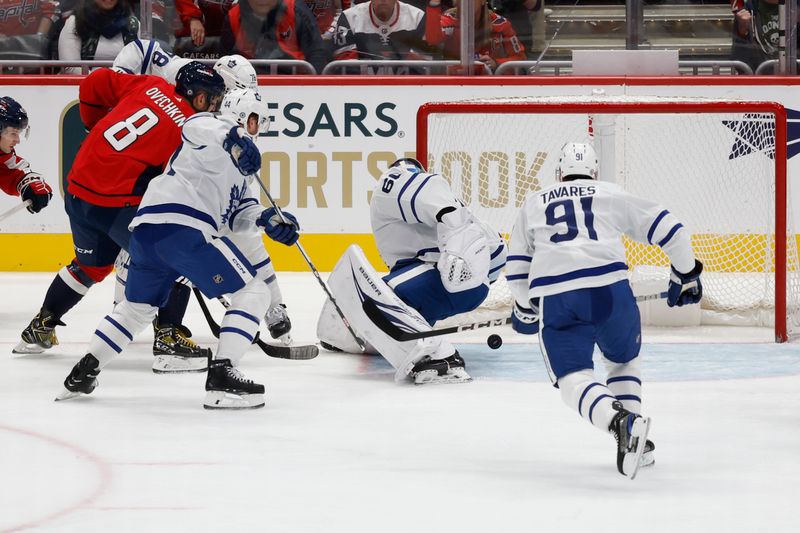 Oct 24, 2023; Washington, District of Columbia, USA; Toronto Maple Leafs goaltender Joseph Woll (60) makes a save on Washington Capitals left wing Alex Ovechkin (8) in the first period at Capital One Arena. Mandatory Credit: Geoff Burke-USA TODAY Sports