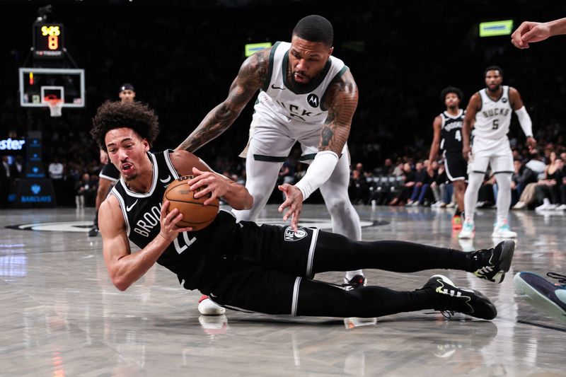 NEW YORK, NEW YORK - DECEMBER 27: Jalen Wilson #22 of the Brooklyn Nets and Damian Lillard #0 of the Milwaukee Bucks dive for a loose ball during the third quarter of the game at Barclays Center on December 27, 2023 in New York City. NOTE TO USER: User expressly acknowledges and agrees that, by downloading and or using this photograph, User is consenting to the terms and conditions of the Getty Images License Agreement. (Photo by Dustin Satloff/Getty Images)