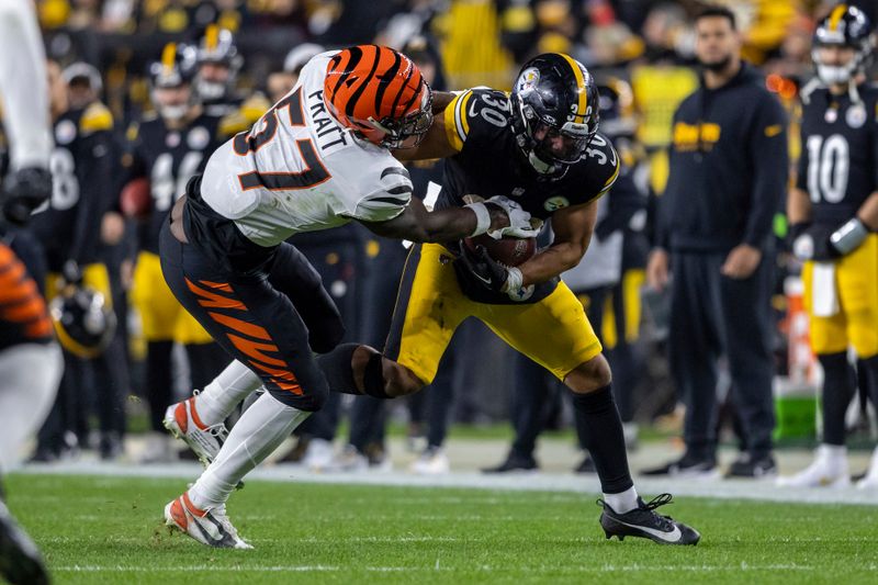 Pittsburgh Steelers running back Jaylen Warren (30) is tackled by Cincinnati Bengals linebacker Germaine Pratt (57) during an NFL football game, Saturday, Dec. 23, 2023, in Pittsburgh. (AP Photo/Matt Durisko)