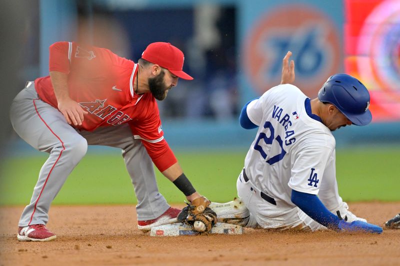 Jun 21, 2024; Los Angeles, California, USA;  Los Angeles Dodgers left fielder Miguel Vargas (27) is save as he beats the tag by Los Angeles Angels second baseman Michael Stefanic (38) after a wild pitch in the third inning at Dodger Stadium. Mandatory Credit: Jayne Kamin-Oncea-USA TODAY Sports
