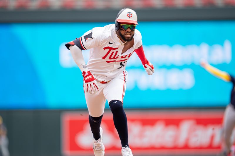 Jul 21, 2024; Minneapolis, Minnesota, USA; Minnesota Twins shortstop Willi Castro (50) slides, trying for a triple and is tagged out by Milwaukee Brewers third base Joey Ortiz (3) in the first inning at Target Field. Mandatory Credit: Matt Blewett-USA TODAY Sports