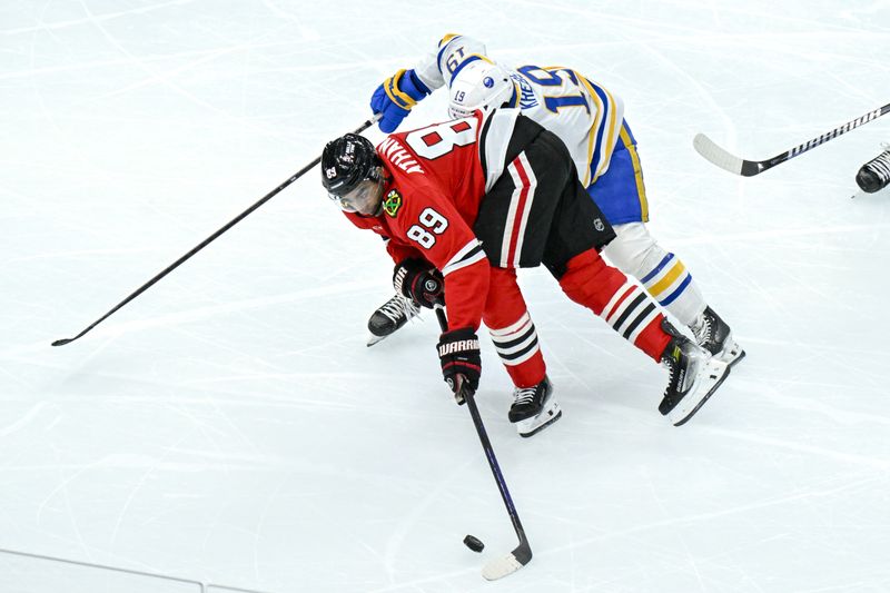 Oct 19, 2024; Chicago, Illinois, USA;  Chicago Blackhawks center Andreas Athanasiou (89) fights for the puck with Buffalo Sabres center Peyton Krebs (19) during the third period at the United Center. Mandatory Credit: Matt Marton-Imagn Images