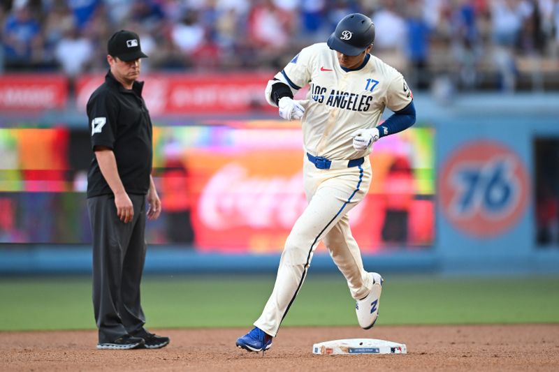 Jun 22, 2024; Los Angeles, California, USA; Los Angeles Dodgers designated hitter Shohei Ohtani (17) hits a home run against the Los Angeles Angels during the third inning at Dodger Stadium. Mandatory Credit: Jonathan Hui-USA TODAY Sports