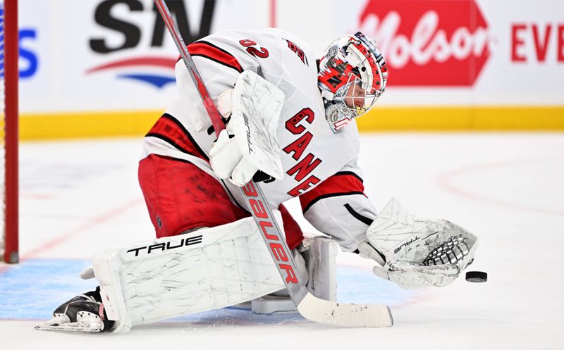 Dec 30, 2023; Toronto, Ontario, CAN; Carolina Hurricanes goalie Pyotr Kochetkov (52) makes a glove save against the Toronto Maple Leafs in the first period at Scotiabank Arena. Mandatory Credit: Dan Hamilton-USA TODAY Sports