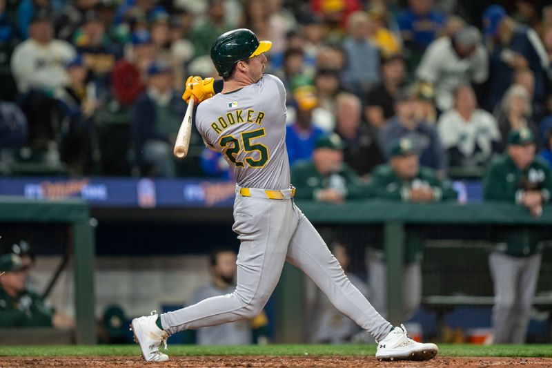 Sep 28, 2024; Seattle, Washington, USA; Oakland Athletics designated hitter Brent Rooker (25) hits a two-run home run during the fifth inning against the Seattle Mariners at T-Mobile Park. Mandatory Credit: Stephen Brashear-Imagn Images