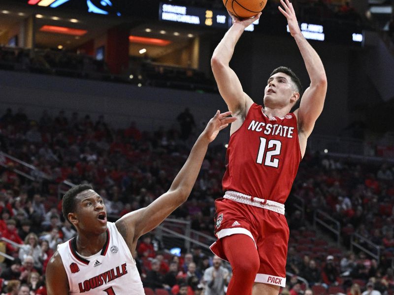 Jan 13, 2024; Louisville, Kentucky, USA;  North Carolina State Wolfpack guard Michael O'Connell (12) shoots against Louisville Cardinals guard Curtis Williams (1) during the first half at KFC Yum! Center. Mandatory Credit: Jamie Rhodes-USA TODAY Sports