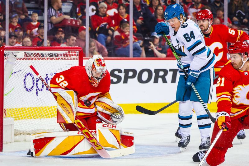 Apr 18, 2024; Calgary, Alberta, CAN; Calgary Flames goaltender Dustin Wolf (32) makes a save against the San Jose Sharks during the first period at Scotiabank Saddledome. Mandatory Credit: Sergei Belski-USA TODAY Sports