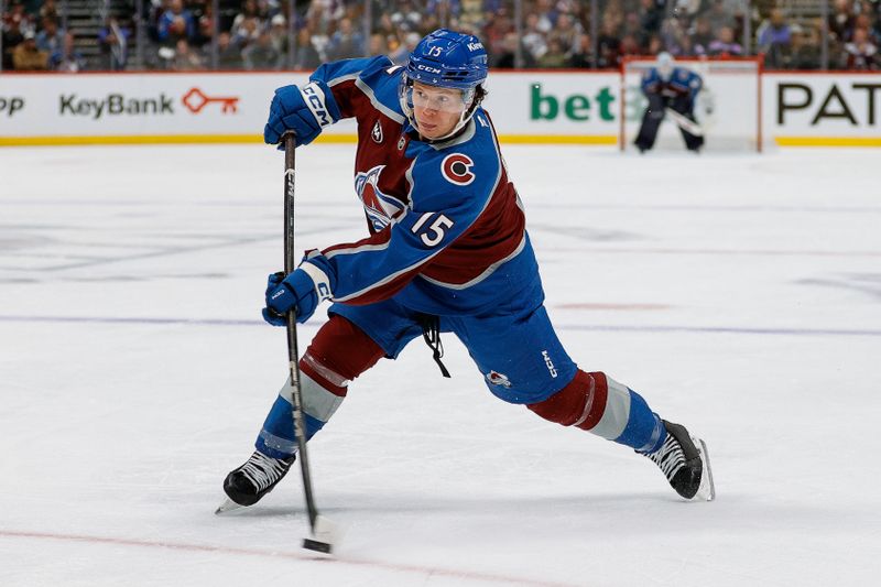 Nov 11, 2025; Denver, Colorado, USA; Colorado Avalanche defenseman Jack Ahcan (15) attempts a shot in the second period against the Anaheim Ducks at Ball Arena. Mandatory Credit: Isaiah J. Downing-Imagn Images