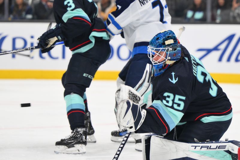 Mar 8, 2024; Seattle, Washington, USA; Seattle Kraken goaltender Joey Daccord (35) blocks a goal shot against the Winnipeg Jets during the first period at Climate Pledge Arena. Mandatory Credit: Steven Bisig-USA TODAY Sports