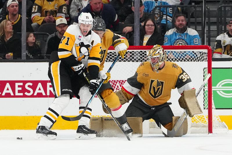 Jan 20, 2024; Las Vegas, Nevada, USA; Vegas Golden Knights goaltender Logan Thompson (36) defends his net as a shot deflects off Pittsburgh Penguins center Evgeni Malkin (71) during the first period at T-Mobile Arena. Mandatory Credit: Stephen R. Sylvanie-USA TODAY Sports