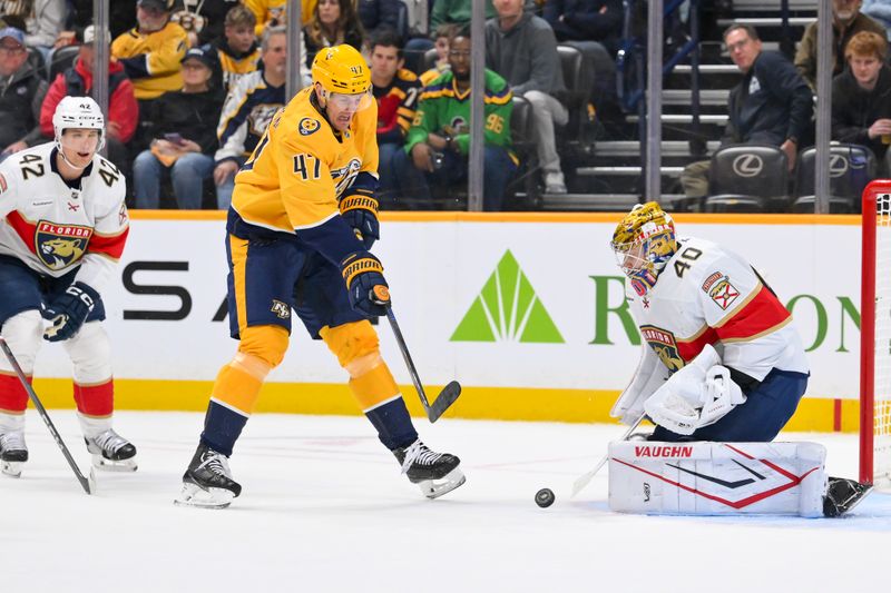 Nov 24, 2025; Nashville, Tennessee, USA;  Florida Panthers goaltender Daniil Tarasov (40) blocks the shot of Nashville Predators right wing Michael McCarron (47) during the first period at Bridgestone Arena. Mandatory Credit: Steve Roberts-Imagn Images