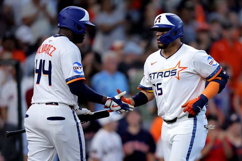 Apr 13, 2025; Houston, Texas, USA; Houston Astros third baseman Isaac Paredes (15) is congratulated by Houston Astros designated hitter Yordan Alvarez (44) after hitting a three run home run to left field against the Los Angeles Angels during the second inning at Daikin Park. Mandatory Credit: Erik Williams-Imagn Images