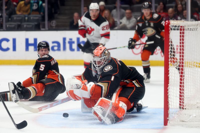 Mar 1, 2024; Anaheim, California, USA; Anaheim Ducks goaltender Lukas Dostal (1) makes a save during the first period against the New Jersey Devils at Honda Center. Mandatory Credit: Kiyoshi Mio-USA TODAY Sports