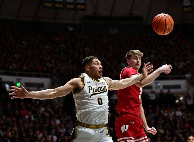 Mar 10, 2024; West Lafayette, Indiana, USA; Purdue Boilermakers forward Mason Gillis (0) and Wisconsin Badgers forward Nolan Winter (31) watch a ball drop from the basket during the first half at Mackey Arena. Mandatory Credit: Marc Lebryk-USA TODAY Sports