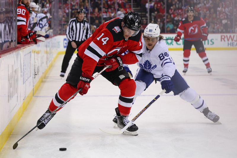 Mar 7, 2023; Newark, New Jersey, USA; New Jersey Devils right wing Nathan Bastian (14) and Toronto Maple Leafs right wing William Nylander (88) battle for the puck during the second period at Prudential Center. Mandatory Credit: Ed Mulholland-USA TODAY Sports