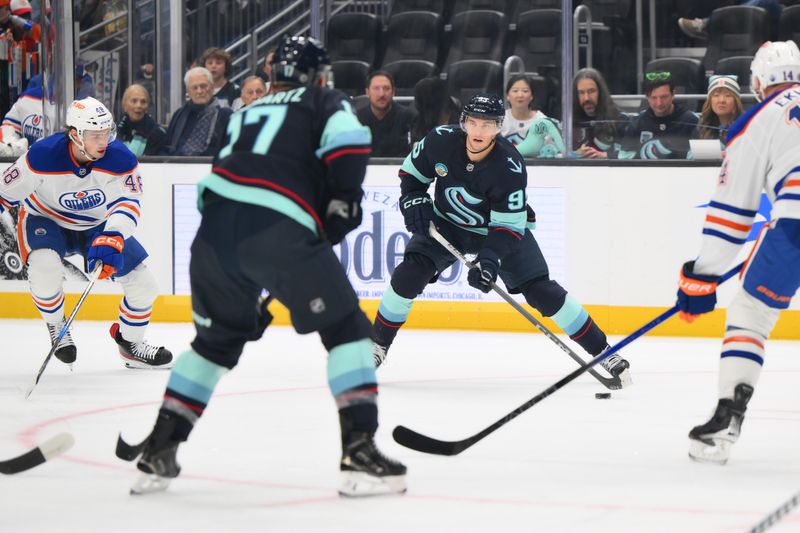 Oct 2, 2024; Seattle, Washington, USA; Seattle Kraken left wing Andre Burakovsky (95) plays the puck against the Edmonton Oilers during the first period at Climate Pledge Arena. Mandatory Credit: Steven Bisig-Imagn Images