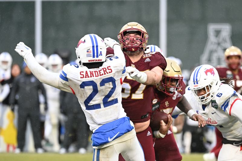 Dec 28, 2023; Boston, MA, USA; Boston College Eagles offensive lineman Jack Conley (67) blocks Southern Methodist Mustangs safety Cale Sanders Jr. (22) during the second half at Fenway Park. Mandatory Credit: Eric Canha-USA TODAY Sports