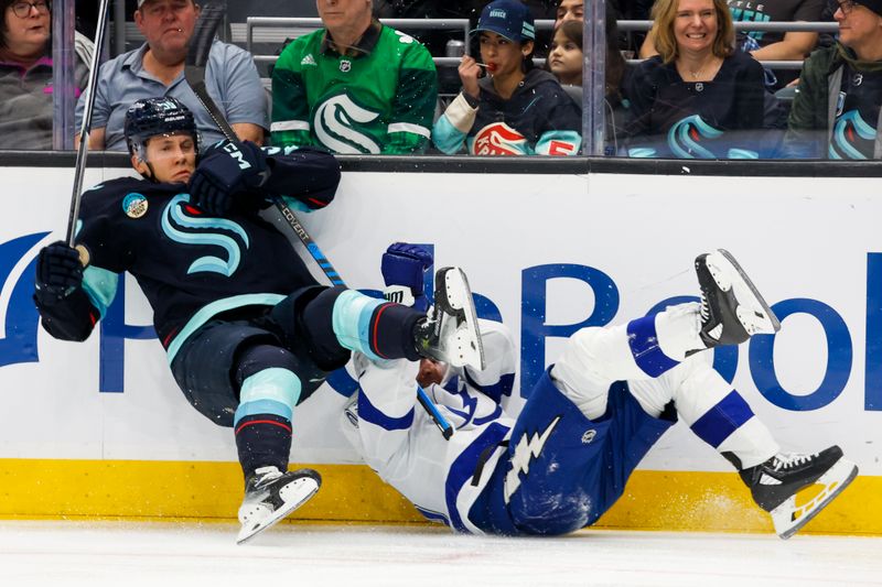 Dec 9, 2023; Seattle, Washington, USA; Seattle Kraken defenseman Ryker Evans (39) and Tampa Bay Lightning center Michael Eyssimont (23) fall to the ice during the first period at Climate Pledge Arena. Mandatory Credit: Joe Nicholson-USA TODAY Sports