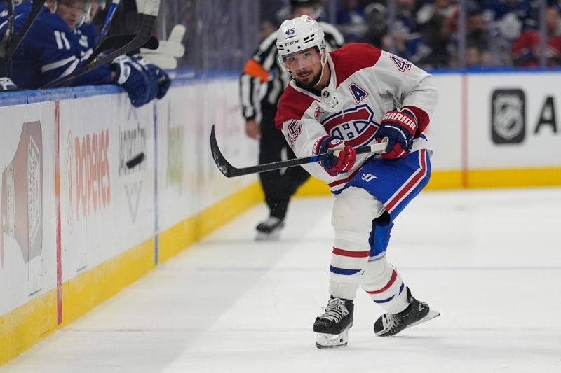 Sep 27, 2025; Toronto, Ontario, CAN; defenseman Alexandre Carrier (45) shoots the puck against the Toronto Maple Leafs during the second period at Scotiabank Arena. Mandatory Credit: John E. Sokolowski-Imagn Images