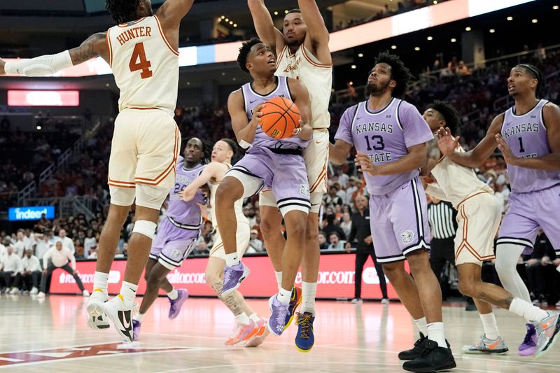 Feb 19, 2024; Austin, Texas, USA; Kansas State Wildcats guard Tylor Perry (2) drives to the basket while defended by Texas Longhorns forward Dylan Disu (1) and guard Tyrese Hunter (4) during the second half at Moody Center. Mandatory Credit: Scott Wachter-USA TODAY Sports