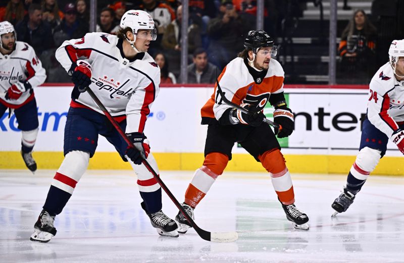 Dec 14, 2023; Philadelphia, Pennsylvania, USA; Philadelphia Flyers right wing Travis Konecny (11) skates against Washington Capitals center Dylan Strome (17) in the first period at Wells Fargo Center. Mandatory Credit: Kyle Ross-USA TODAY Sports