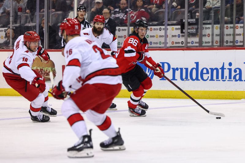 Nov 21, 2024; Newark, New Jersey, USA; New Jersey Devils center Jack Hughes (86) skates with the puck against the Carolina Hurricanes during the second period at Prudential Center. Mandatory Credit: Ed Mulholland-Imagn Images