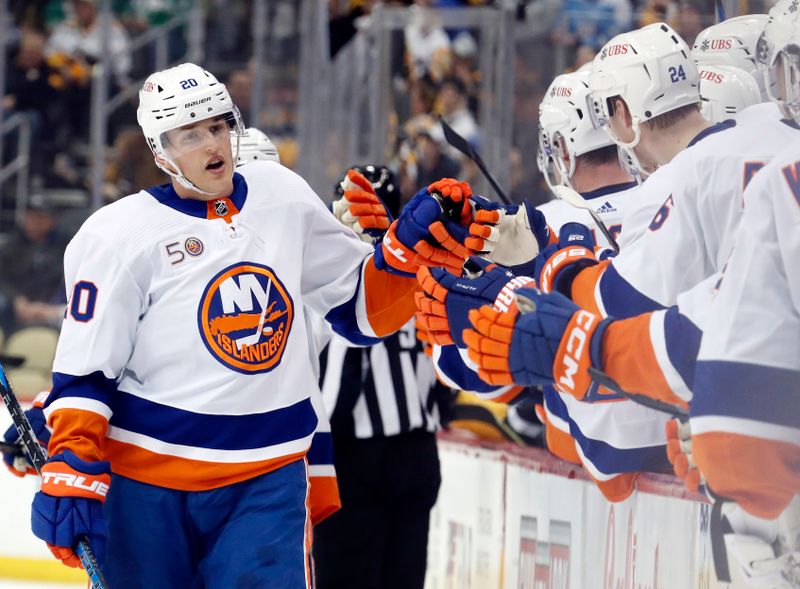 Mar 9, 2023; Pittsburgh, Pennsylvania, USA;  New York Islanders right wing Hudson Fasching (20) celebrates with the Islanders bench after scoring a goal against the Pittsburgh Penguins during the third period at PPG Paints Arena. The Islanders won 4-3 in overtime. Mandatory Credit: Charles LeClaire-USA TODAY Sports