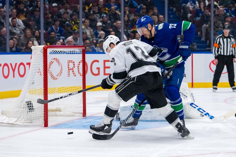 Jan 16, 2025; Vancouver, British Columbia, CAN; Vancouver Canucks defenseman Vincent Desharnais (73) checks Los Angeles Kings forward Trevor Moore (12) in the third period at Rogers Arena. Mandatory Credit: Bob Frid-Imagn Images