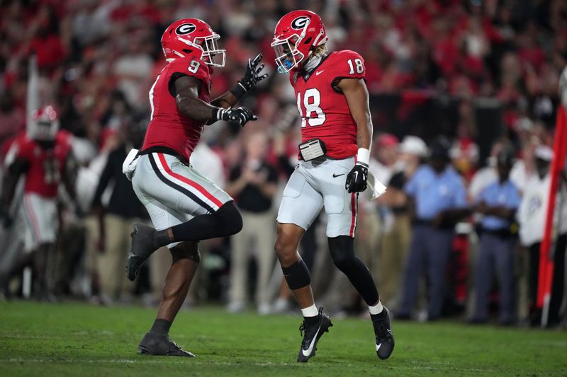 Sep 23, 2023; Athens, Georgia, USA; Georgia Bulldogs linebacker Xavian Sorey Jr. (18) and linebacker Troy Bowles (0) celebrate against the UAB Blazers in the second half at Sanford Stadium. Mandatory Credit: Kirby Lee-USA TODAY Sports